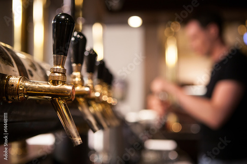 A lot of Golden beer taps at the bar