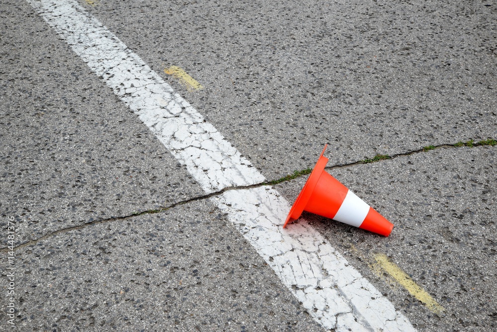line on the asphalt overturned and post warning