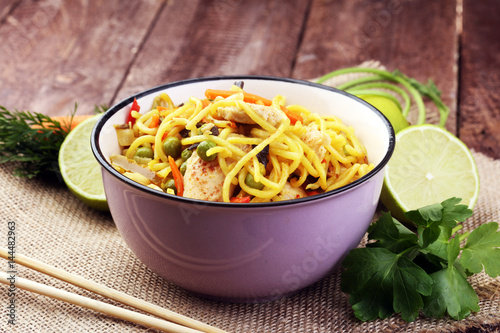 Traditional indonesian meal bami goreng with noodles, vegetables and chicken photo