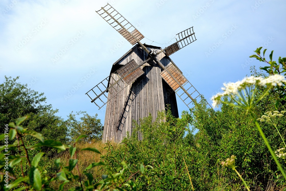 old grain mill against a blue sky
