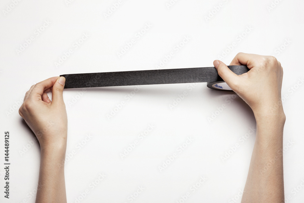 woman(female) hand hold a black tape isolated white. woman(female) hand hold a black tape isolated white.