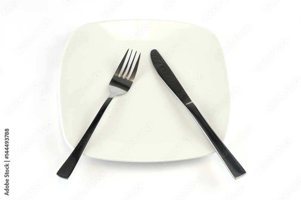 Fototapeta premium fork and knife in white plate isolated on background