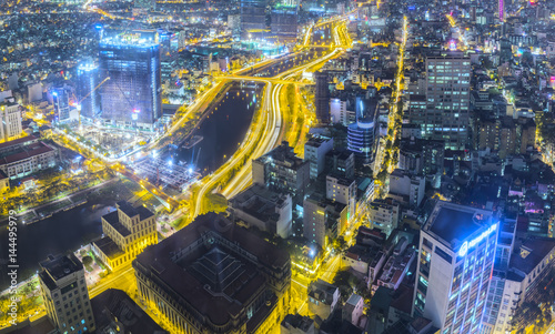 Ho Chi Minh City, Vietnam - April 11, 2017: Night city skyline with lightstreet riverside create shimmering nocturnal beauty of the city is developing dynamically in Ho Chi Minh City, Vietnam