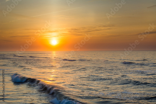 Sunrise over waves in the Atlantic Ocean in Ventnor City, New Jersey.