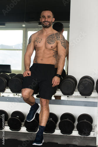 Muscular Man After Exercise Resting In Gym