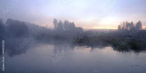 Twilight.Foggy autumn landscape with river