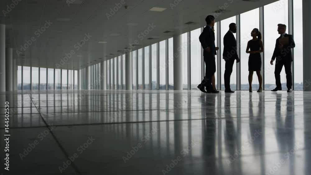  Business team viewing empty commercial property & shaking hands with agents