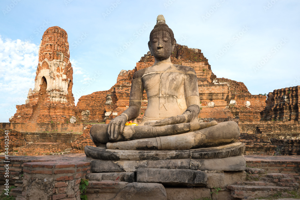 Ancient sculpture of the sitting Buda close up. Ruins of the Buddhist temple Wat Mahathat in Ayutthaya, Thailand