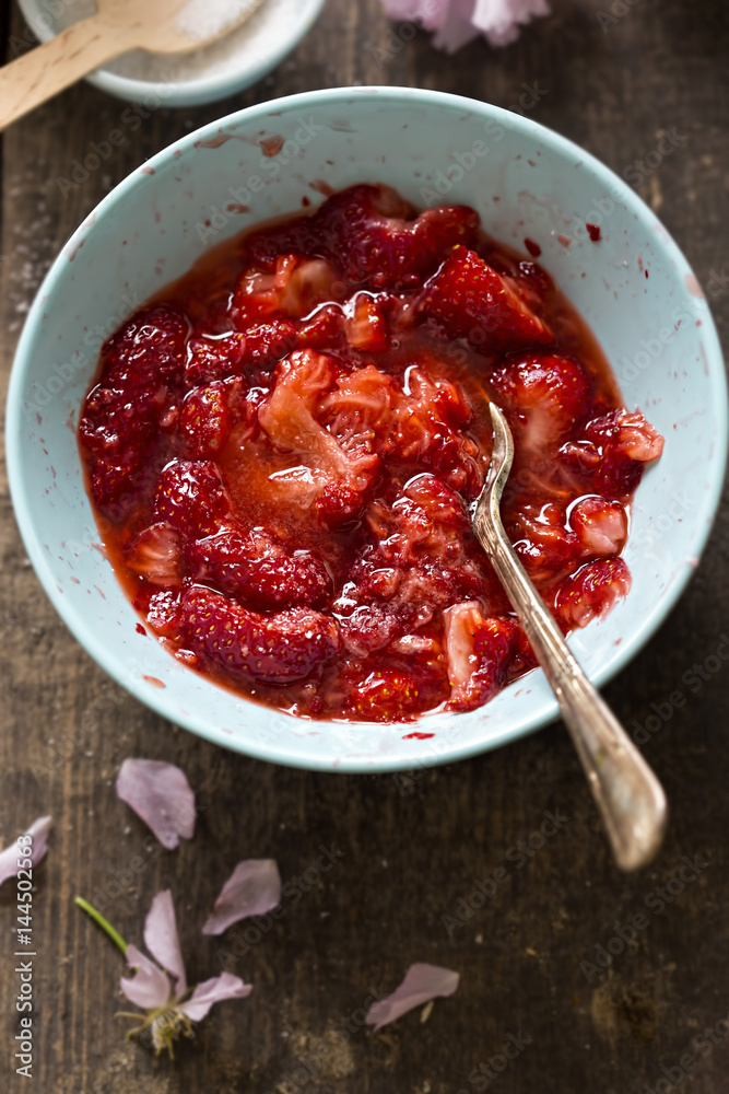 Fresh strawberries with sugar mashed with fork Fresh strawberries with sugar mashed with fork
