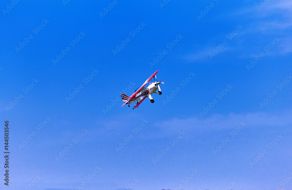 Flight of a sport aircraft against a blue sky. Flight of a sport aircraft against a blue sky.