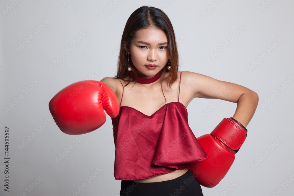 Young Asian woman with red boxing gloves. Young Asian woman with red boxing gloves.