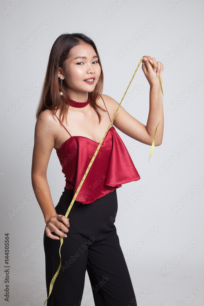 Young Asian woman with measuring tape. Young Asian woman with measuring tape.