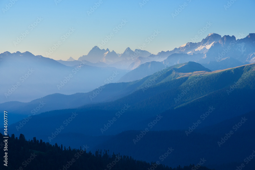 The first rays of the sun illuminate the mountain in the Western Caucasus