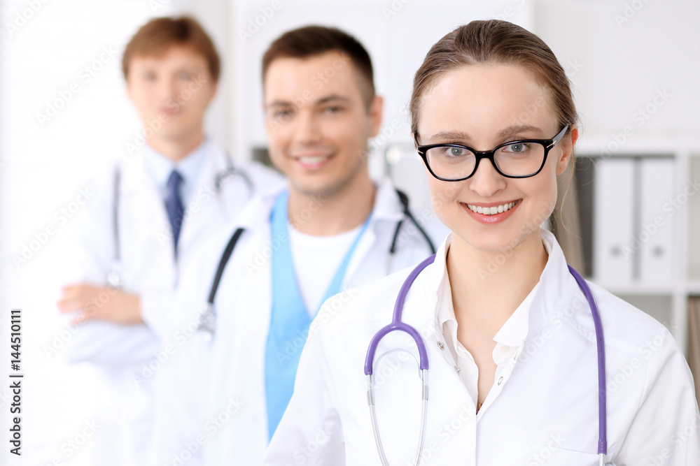 Happy doctor woman with medical staff at the hospital Happy doctor woman with medical staff at the hospital