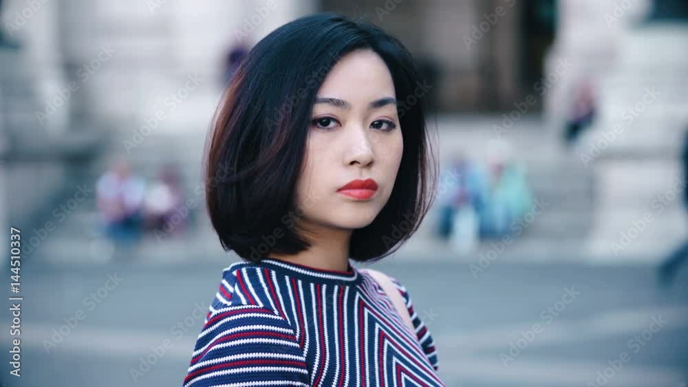 Close up of serious and proud chinese woman looking at the camera Close up of serious and proud chinese woman looking at the camera