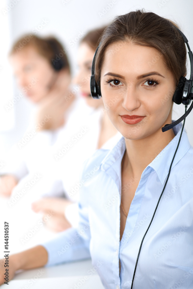 Call center. Focus on beautiful business woman in headset. Call center. Focus on beautiful business woman in headset.