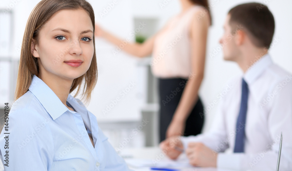 Portrait of a young business woman at meeting. Portrait of a young business woman at meeting.