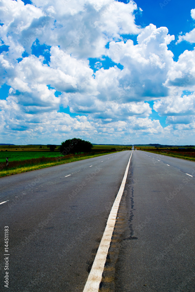 Long road ahead under a blue sky Stock Photo | Adobe Stock