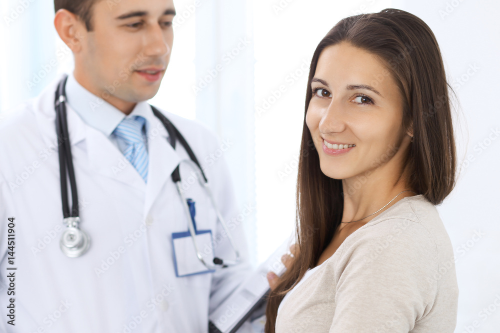 Confident male doctor and patient