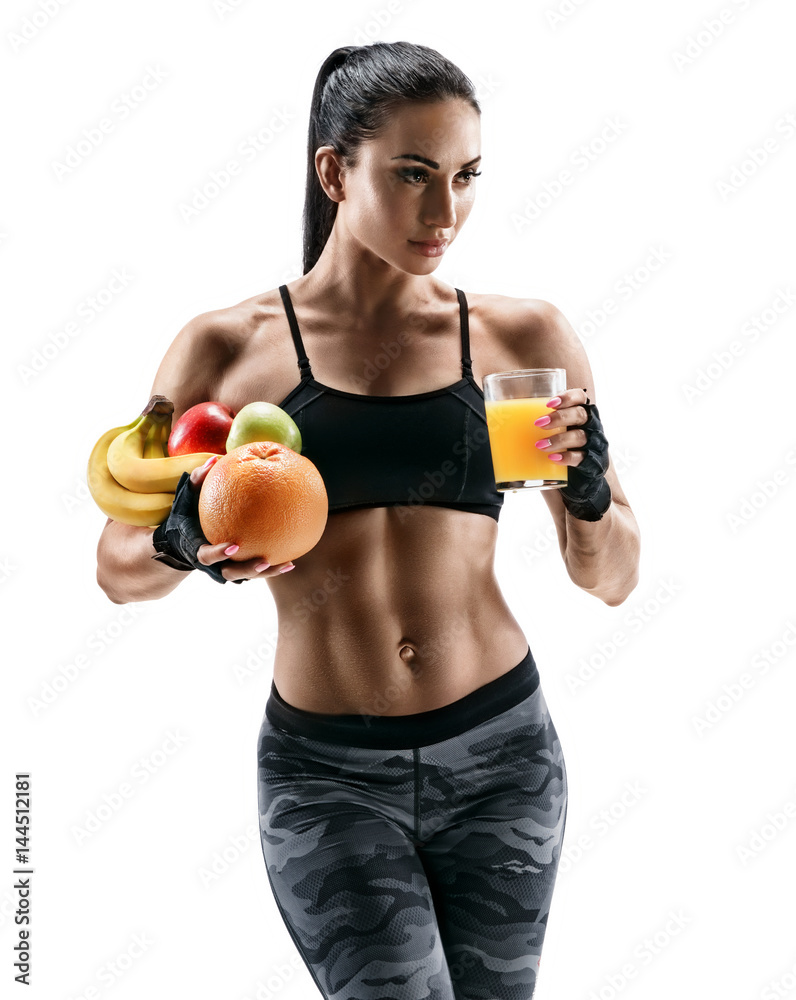 Resting time. Athletic young woman in sports wear hold fresh fruits and glass orange juice. Organic food and health concept Resting time. Athletic young woman in sports wear hold fresh fruits and glass orange juice. Organic food and health concept