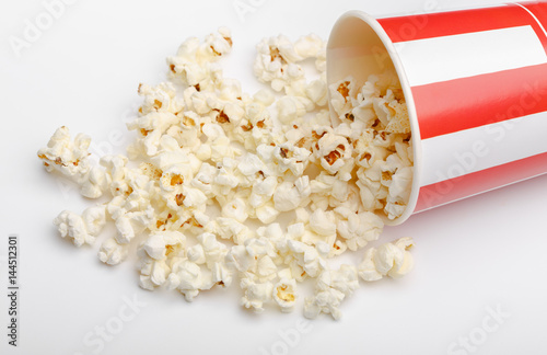 Popcorn in red and white cardboard box. Popcorn border isolated on white. Film. Fast food. Corn