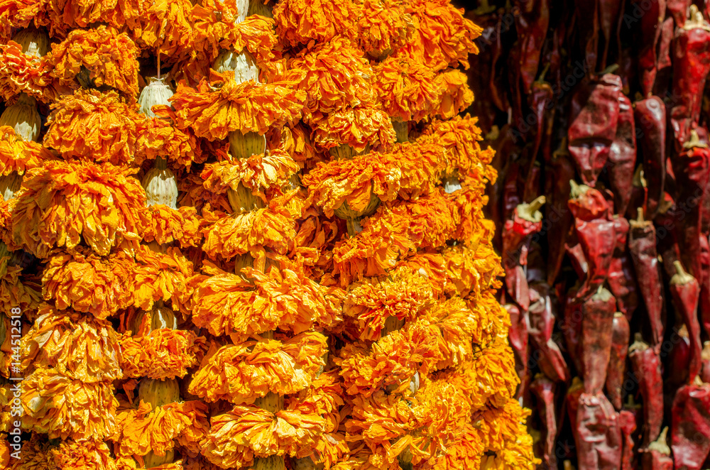 Dried spices on the market hang down.