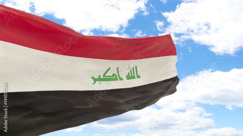 Waving flag of Iraq on the blue cloudy sky. photo