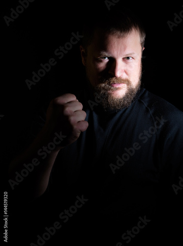 Solid bearded middle-aged man shakes his fist © idea_studio