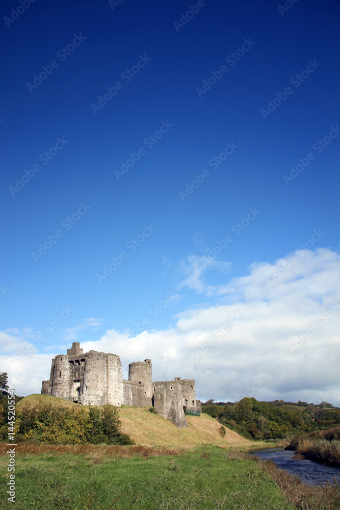 Kidwelly Castle by the River Gwendraeth is a ruin of a 13th century medieval castle and a popular tourist attraction Kidwelly Castle by the River Gwendraeth is a ruin of a 13th century medieval castle and a popular tourist attraction