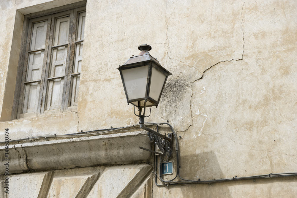 Old iron window with wooden edges on a Spanish street. Traditional architecture in spain