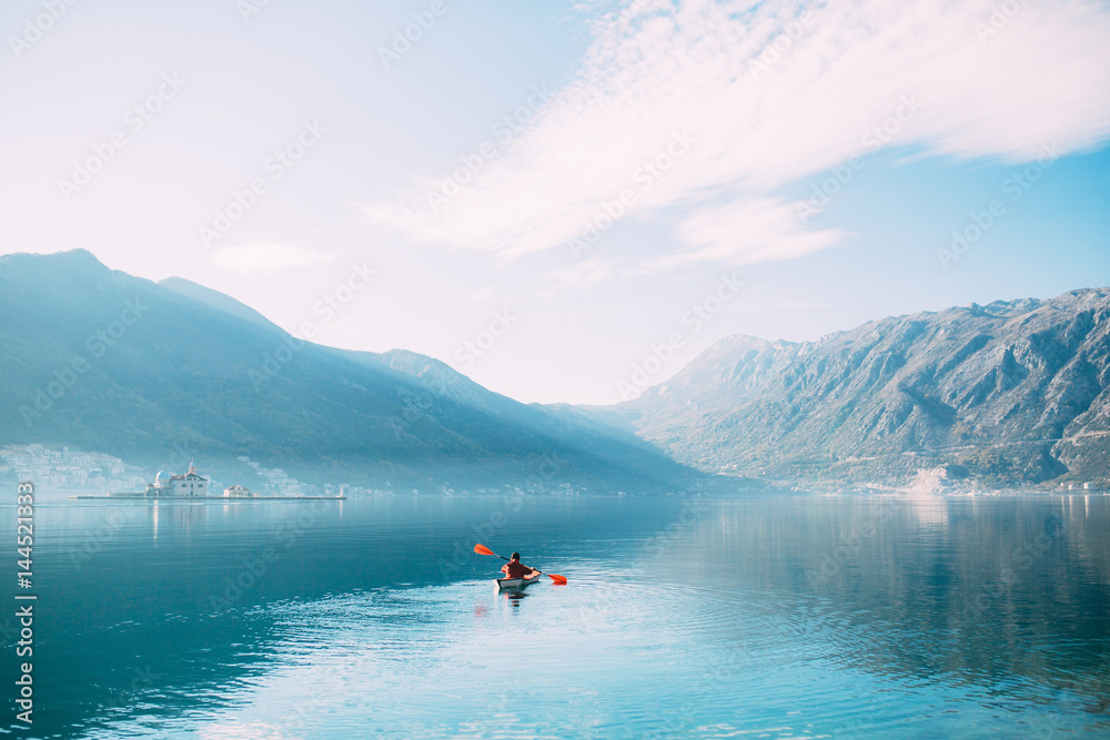 Fototapeta Kayaks in the lake. Tourists kayaking on the Bay of Kotor, near the town of Perast in Montenegro. Aerial Photo drone.