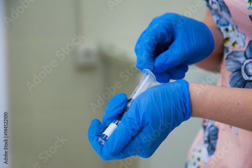 Syringe, medical injection in hand