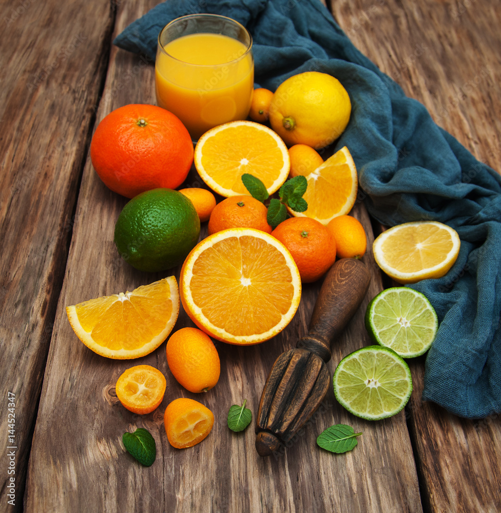 Fresh citrus fruits and old juicer Fresh citrus fruits and old juicer
