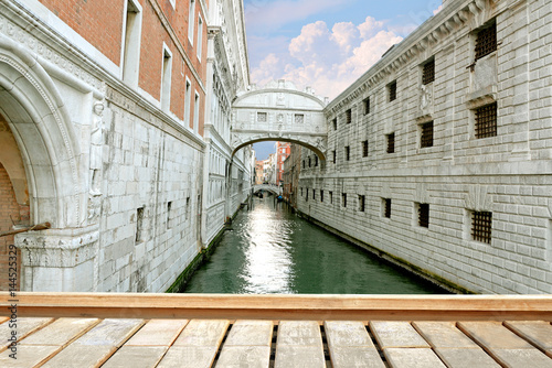 Gondola on small canal passing towards famous Bridge of Sighs (Ponte dei Sospiri) in Venice, Italy.