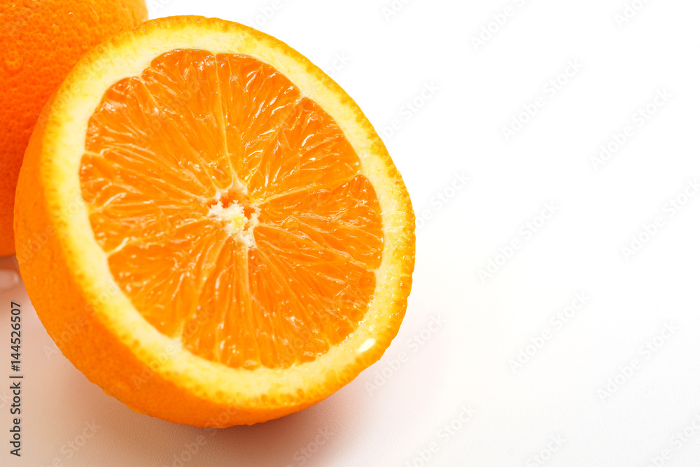 Orange cut in half on white background, selective focused. Orange cut in half on white background, selective focused.