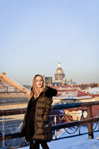 Picture of a girl against a background of snow and the city