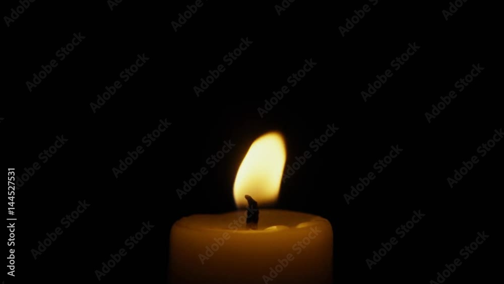 Candle burns and goes out in the wind on a black background close-up. Slow motion Candle burns and goes out in the wind on a black background close-up. Slow motion