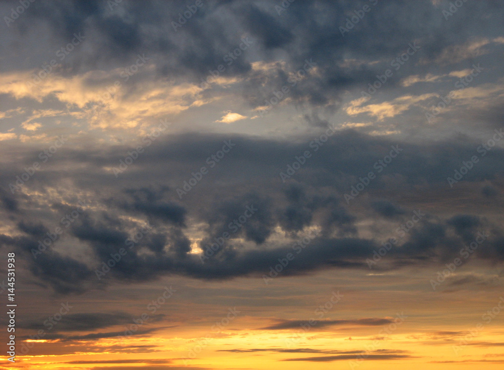 Yellow and grey clouds background, sunset, horizontal view.