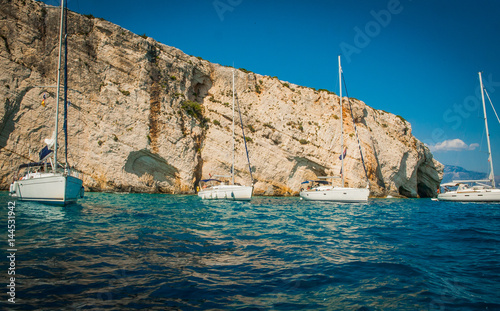 Greece, Zakynthos, August 2016. Rocks, caves and blue water, boats in harbour