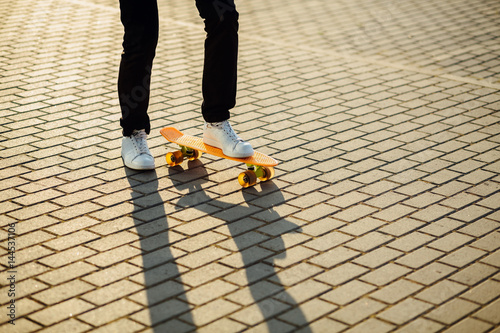 Hipster boy with skateboard outdoors. Closeup skateboarding. Active sporty man having fun outdoor.