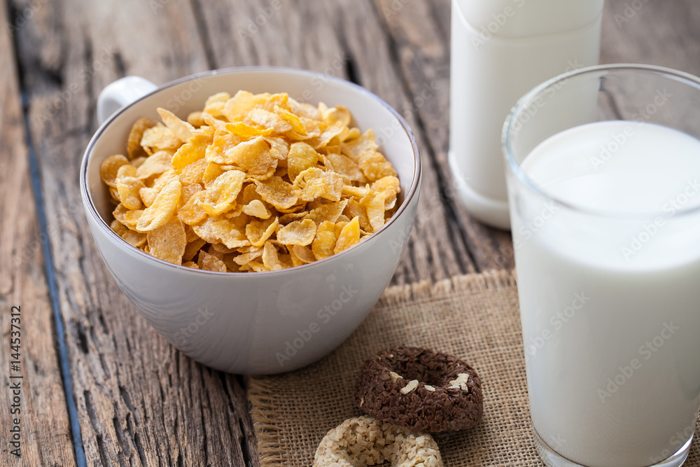 milk, cookies and bowl of cereal on wooden background milk, cookies and bowl of cereal on wooden background