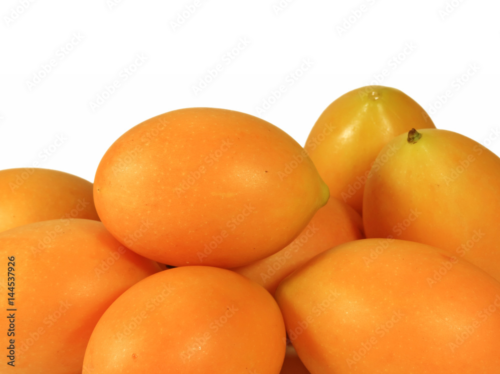 Heap of Vibrant Yellow Fresh Ripe Marian Plums Isolated on White Background Heap of Vibrant Yellow Fresh Ripe Marian Plums Isolated on White Background