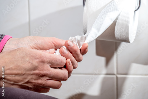 Close-up Of A lady's Hand Using Toilet Paper