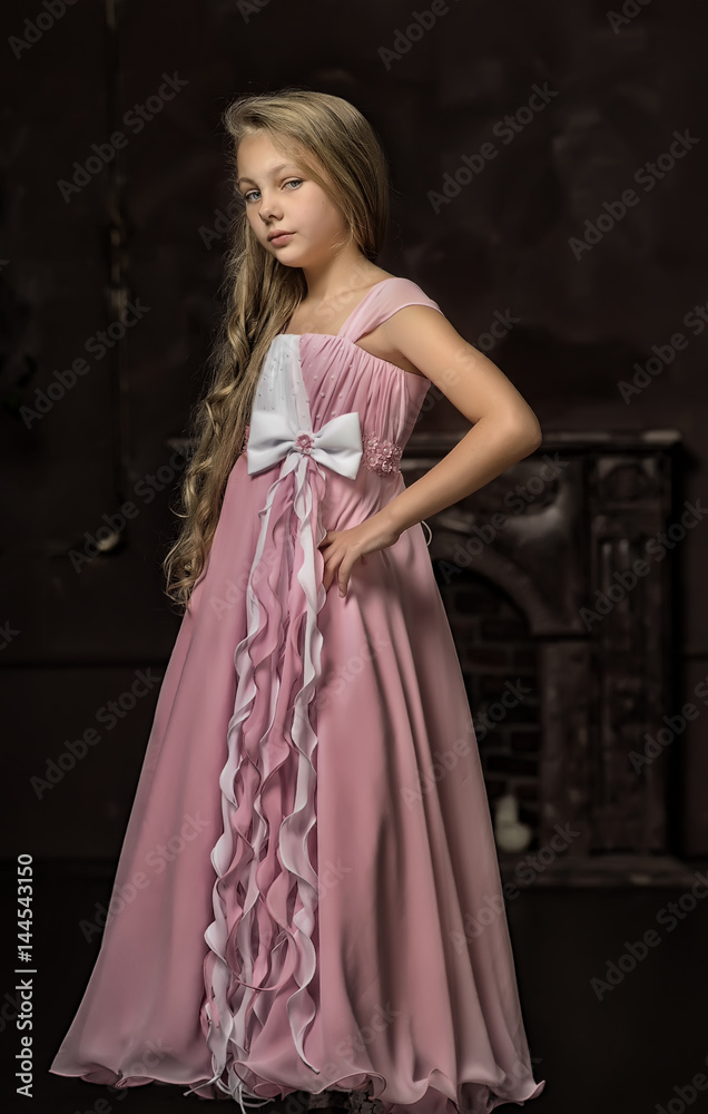 Beautiful young blonde girl with long hair in a pink Beautiful young blonde girl with long hair in a pink