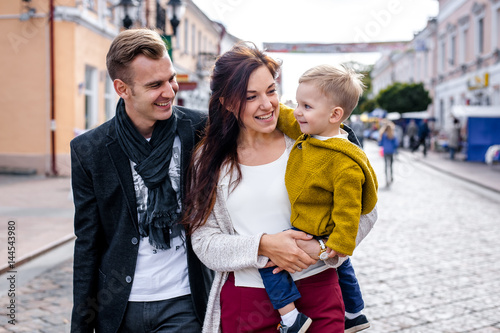 Happy family walking on the street in the city