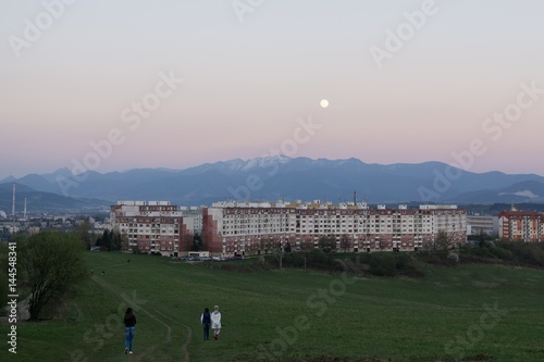 Full moon over the mountains and city. Slovakia