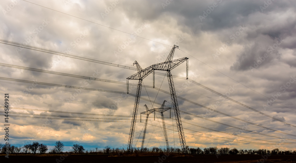 high-voltage power lines at sunset. electricity distribution station. high voltage electric transmission tower