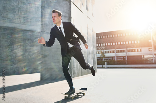 Photography Confident skater wearing suit riding in city