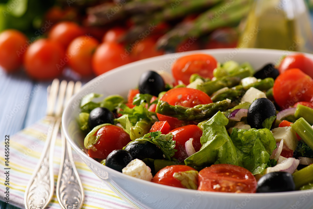 Vegetable salad with asparagus, tomatoes, feta cheese and olives. Vegetable salad with asparagus, tomatoes, feta cheese and olives.