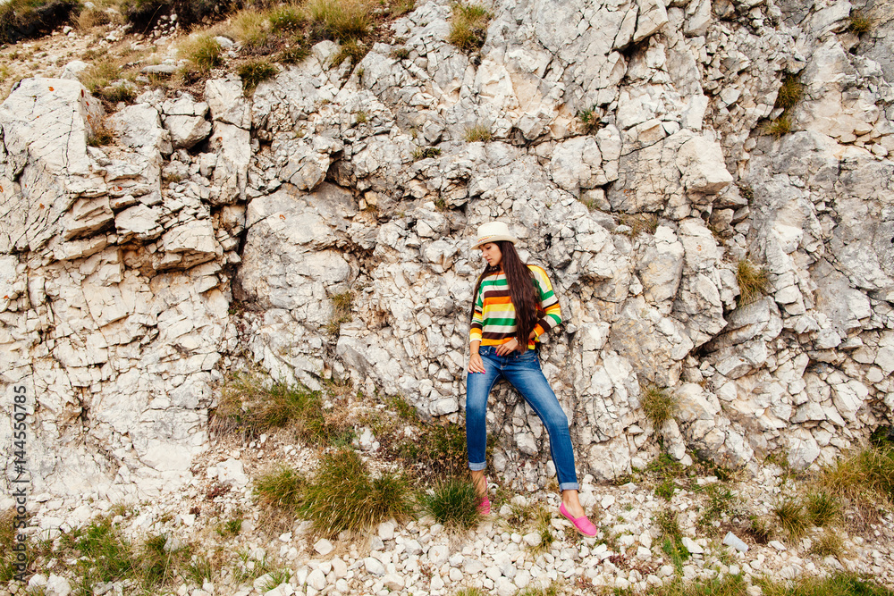 long hair woman posing in rocks long hair woman posing in rocks